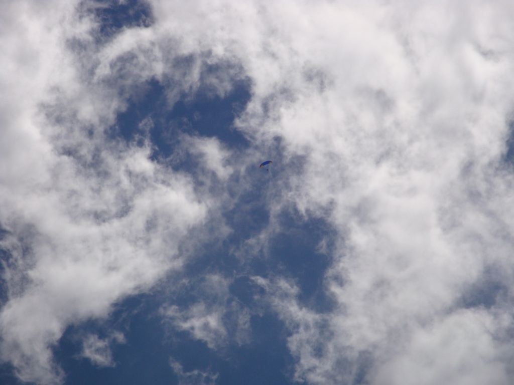 paraglider thermalling at cloud base